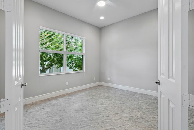 spare room with ceiling fan