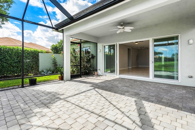 unfurnished sunroom with ceiling fan