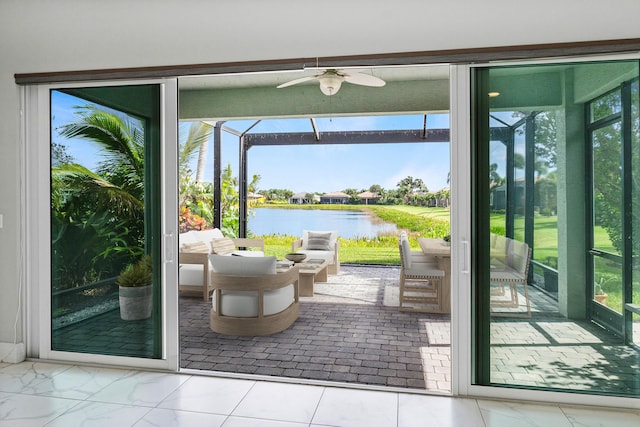 doorway to outside with plenty of natural light, ceiling fan, and a water view