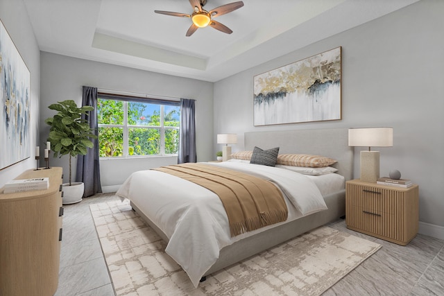 bedroom featuring ceiling fan and a tray ceiling