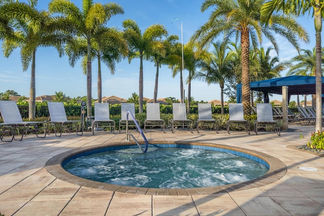 view of pool with a hot tub and a patio area