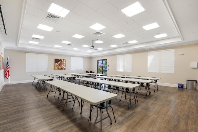 playroom featuring a raised ceiling, dark wood-type flooring, and a drop ceiling