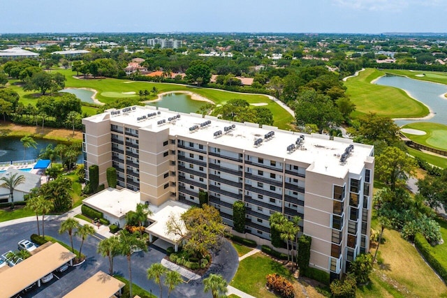 birds eye view of property featuring view of golf course and a water view