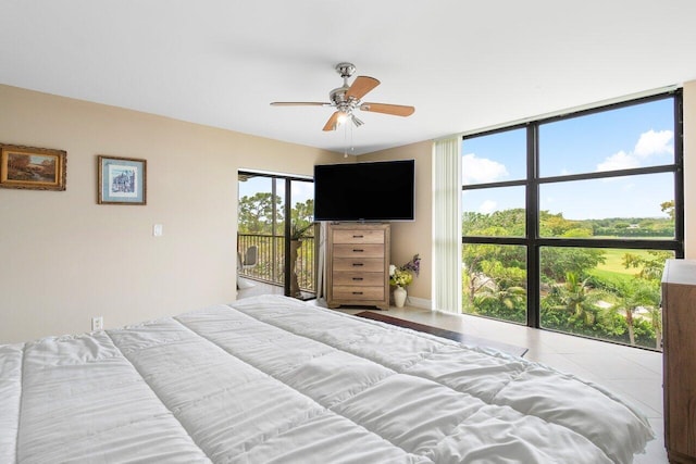 tiled bedroom featuring access to outside, expansive windows, and ceiling fan