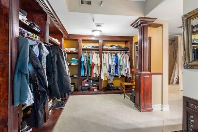 spacious closet with ornate columns and visible vents