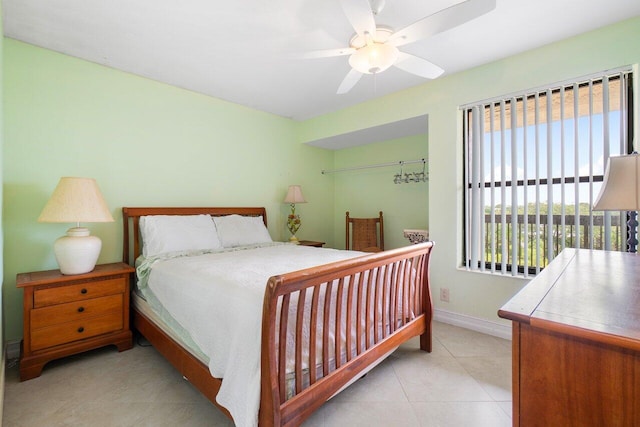 bedroom with a ceiling fan, baseboards, and tile patterned floors