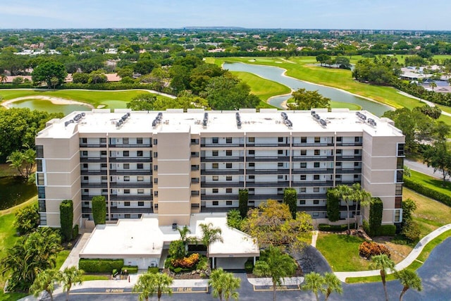 drone / aerial view with a water view and golf course view