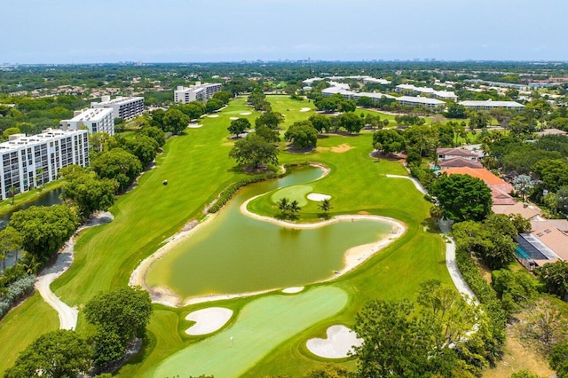 drone / aerial view featuring view of golf course and a water view