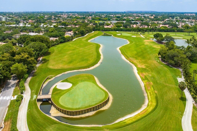 drone / aerial view with a water view and golf course view