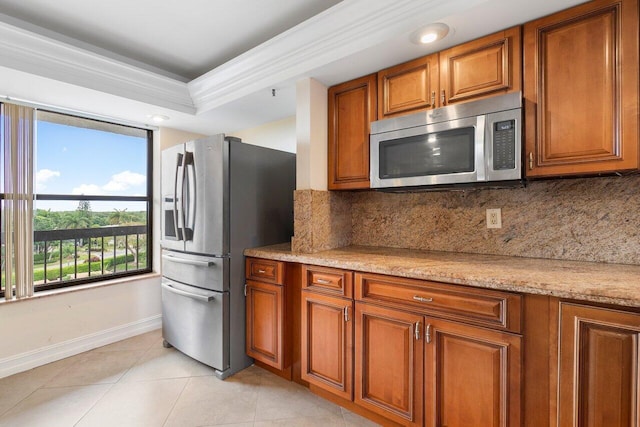 kitchen featuring appliances with stainless steel finishes, brown cabinets, and backsplash