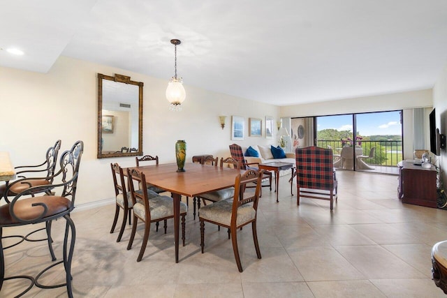 dining space with light tile patterned floors and baseboards