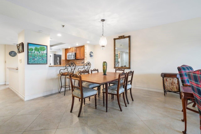 dining area featuring recessed lighting, baseboards, and light tile patterned floors