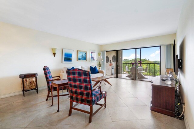 living area with light tile patterned floors and baseboards