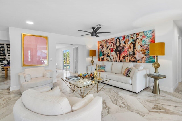 living area featuring visible vents, baseboards, marble finish floor, and ceiling fan