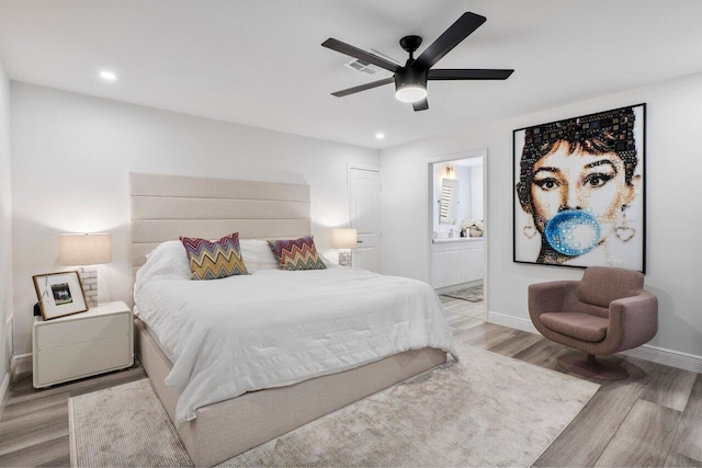 bedroom with light wood-type flooring, visible vents, recessed lighting, connected bathroom, and baseboards