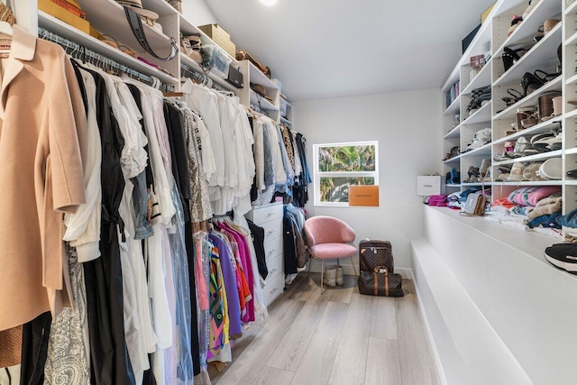 walk in closet with wood finished floors