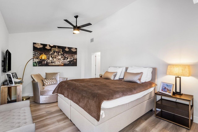 bedroom featuring visible vents, wood finished floors, baseboards, lofted ceiling, and ceiling fan