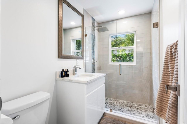 full bath with recessed lighting, a shower stall, toilet, and vanity