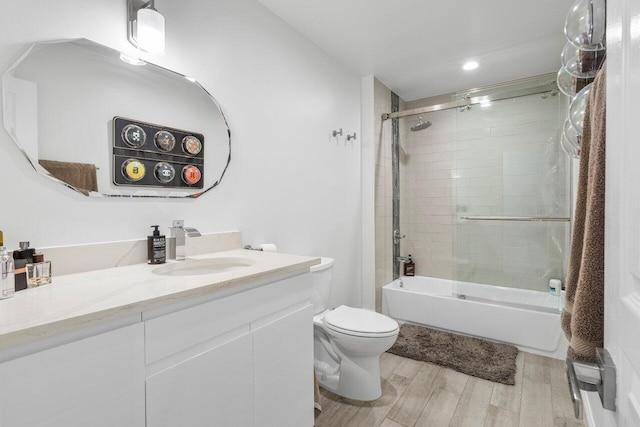 full bath featuring toilet, vanity, shower / bathing tub combination, and wood finished floors