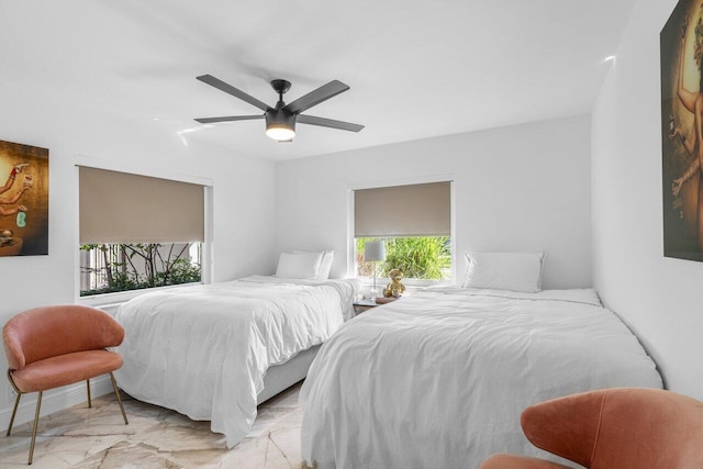 bedroom with marble finish floor and ceiling fan