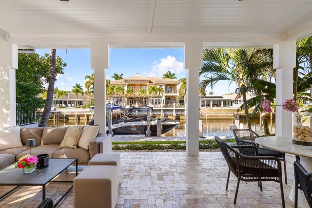 sunroom featuring a water view