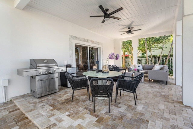 view of patio featuring grilling area, fence, an outdoor hangout area, outdoor dining area, and a ceiling fan