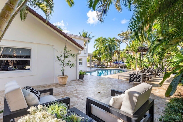 view of patio / terrace featuring an outdoor pool and an outdoor hangout area