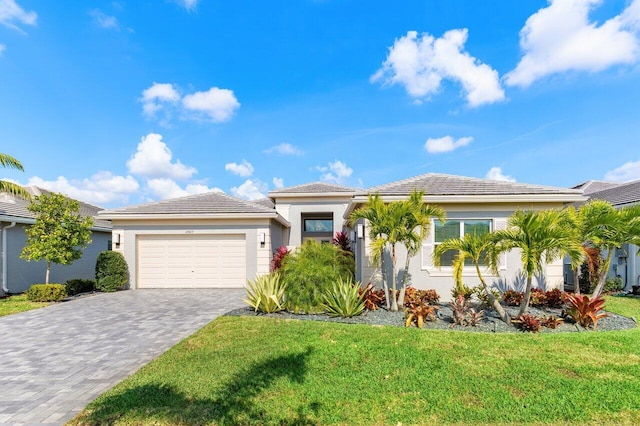 view of front of property featuring stucco siding, an attached garage, decorative driveway, and a front yard