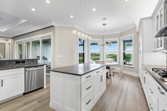 kitchen with white cabinetry, light wood-style flooring, a notable chandelier, and appliances with stainless steel finishes