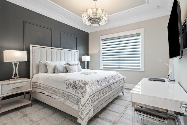 bedroom featuring a tray ceiling and crown molding