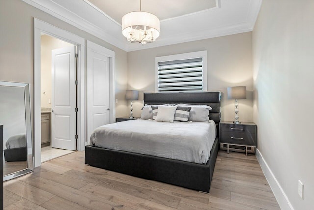 bedroom with a notable chandelier, light wood-style floors, baseboards, and ornamental molding