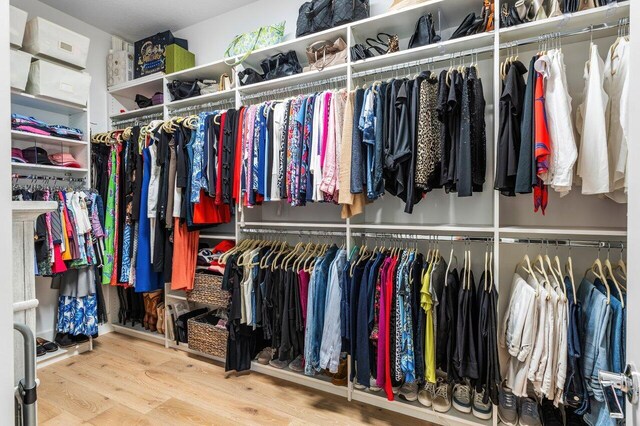 spacious closet with wood finished floors