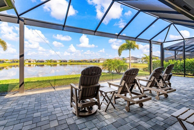 view of patio / terrace featuring glass enclosure and a water view