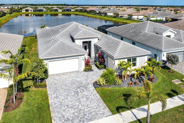 bird's eye view featuring a residential view and a water view