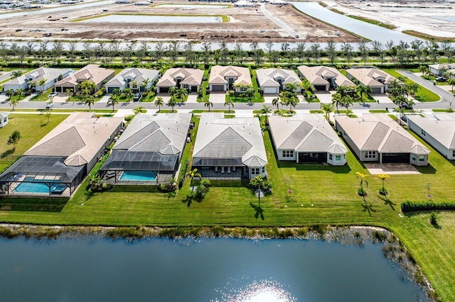 bird's eye view with a residential view and a water view