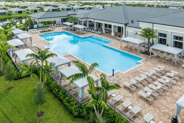 community pool with a patio and a residential view