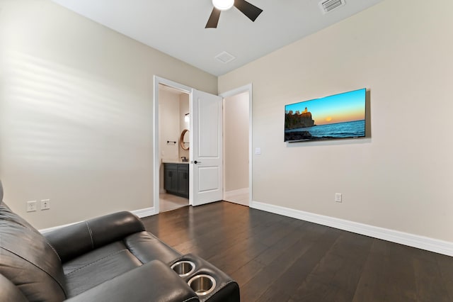 unfurnished living room featuring baseboards, visible vents, ceiling fan, and dark wood-type flooring