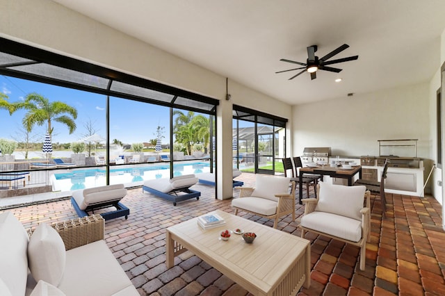 interior space featuring ceiling fan, exterior kitchen, a lanai, and a community pool