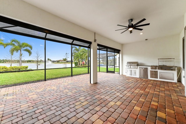 unfurnished sunroom with a water view and a ceiling fan