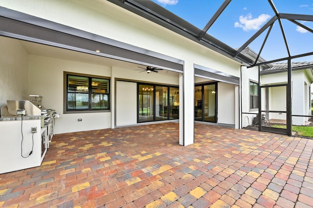 exterior space with a lanai, ceiling fan, and an outdoor kitchen