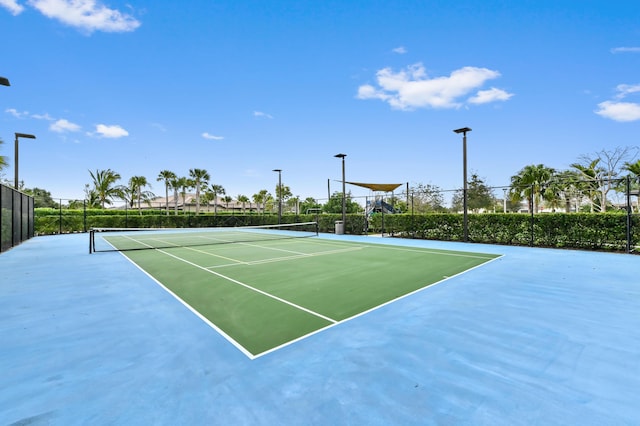 view of tennis court featuring fence