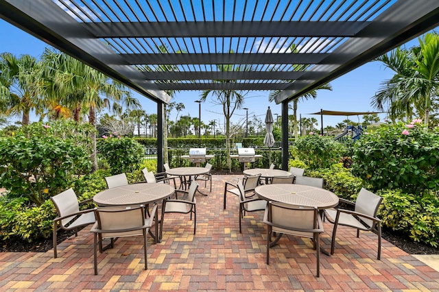 view of patio with outdoor dining space, fence, and a pergola