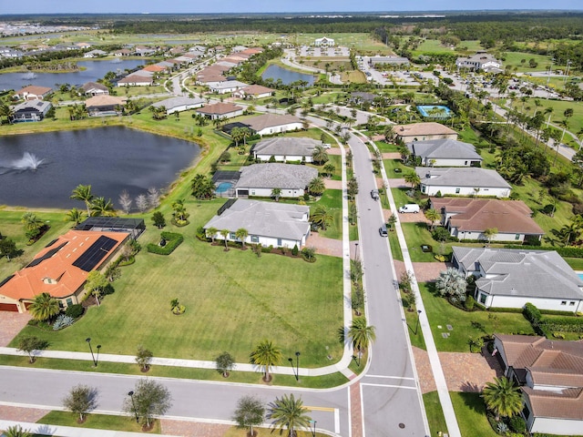 birds eye view of property featuring a water view and a residential view