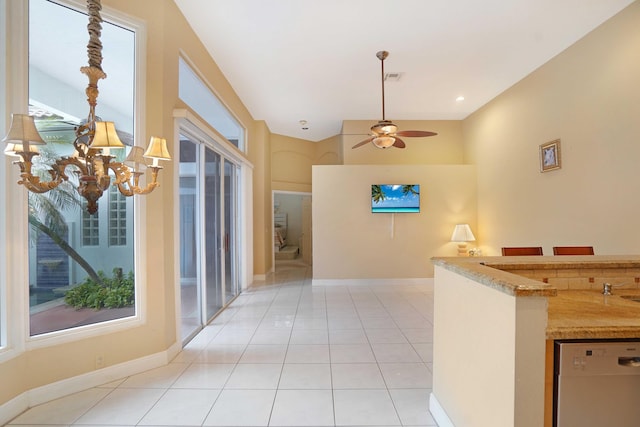 hall featuring a healthy amount of sunlight, visible vents, baseboards, and light tile patterned floors