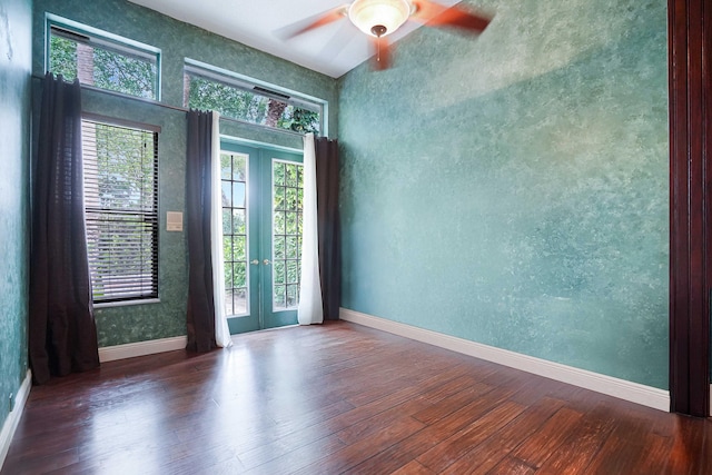 spare room with french doors, dark wood-type flooring, and baseboards