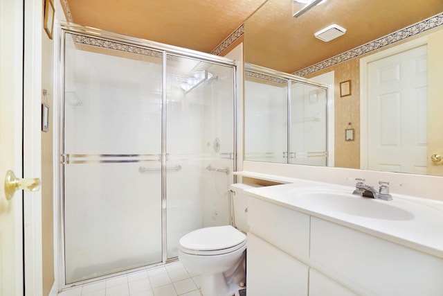 bathroom with vanity, a shower stall, toilet, and tile patterned floors