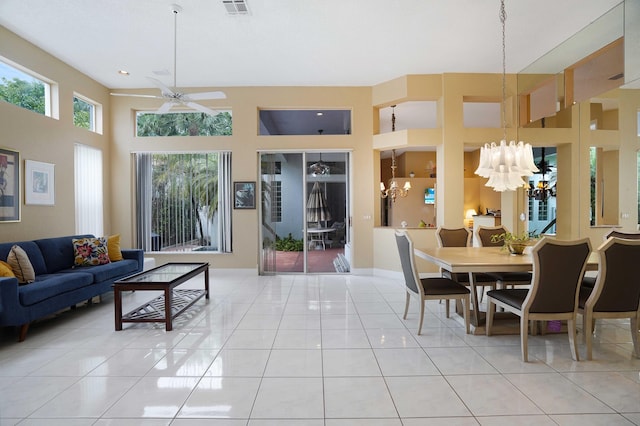 dining room featuring tile patterned flooring and ceiling fan with notable chandelier