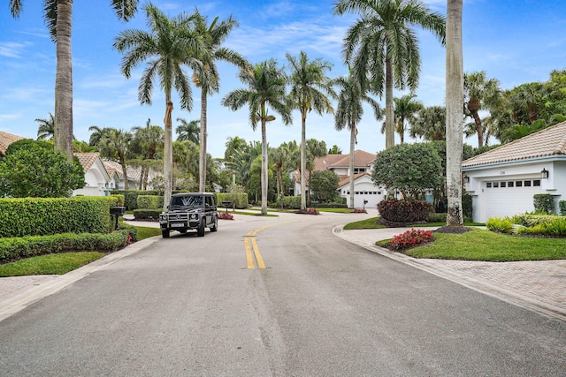 view of street featuring a residential view and curbs