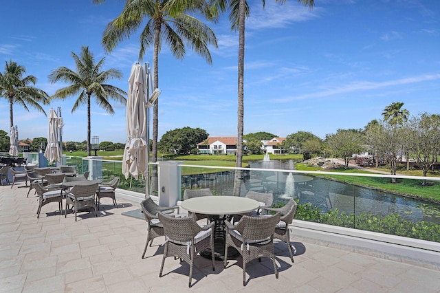 view of patio featuring outdoor dining area and a water view