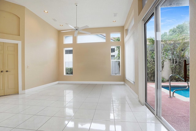 spare room with recessed lighting, light tile patterned flooring, a ceiling fan, and baseboards